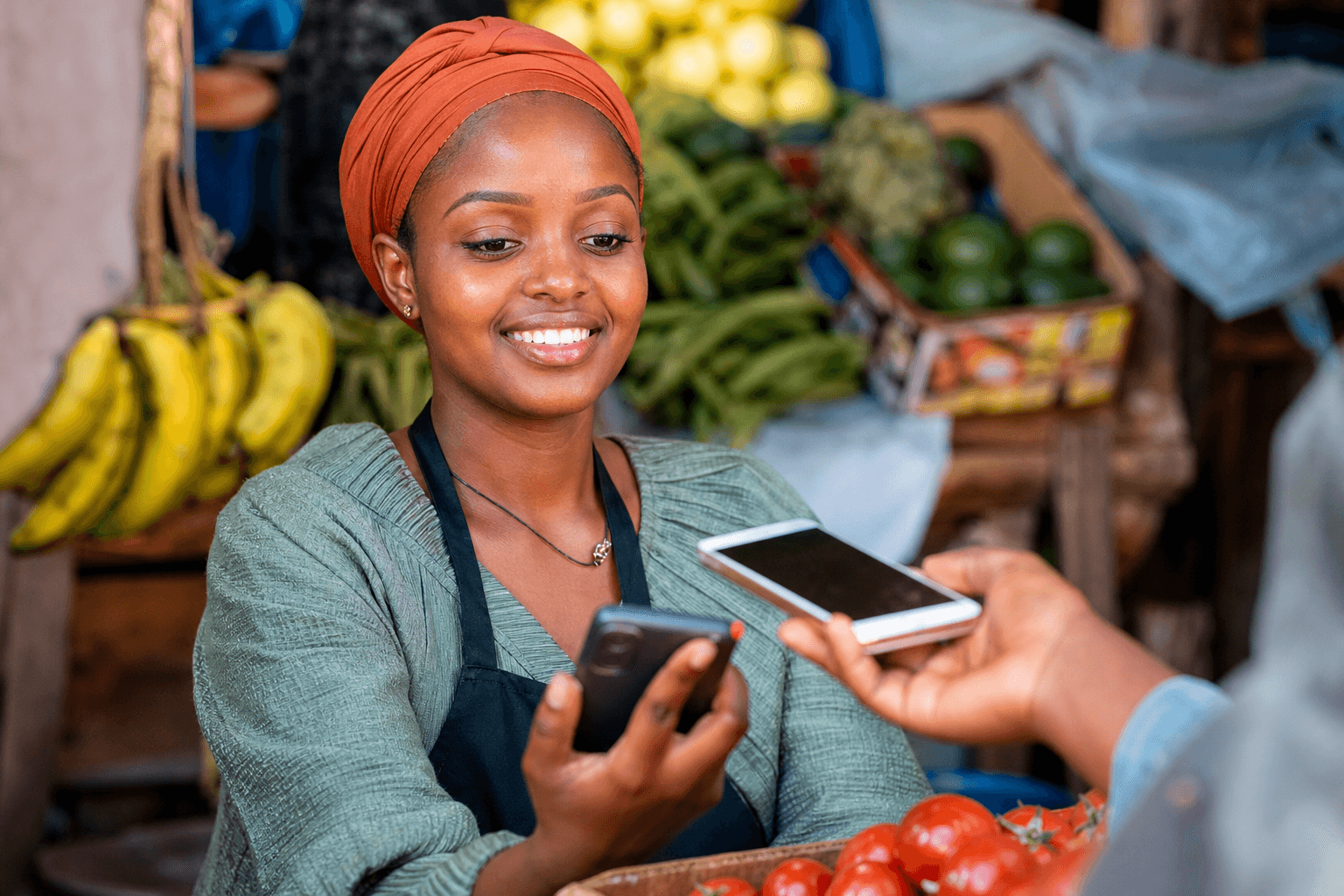 Trader using a smartphone to receive a mobile payment at a stall